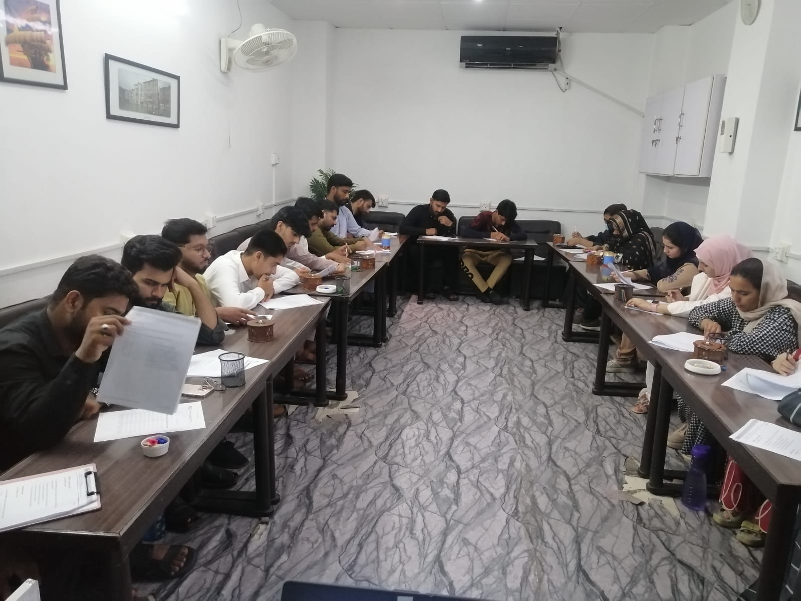 An IELTS class in session at 4Skills in Faisalabad, students working through practice papers at desks