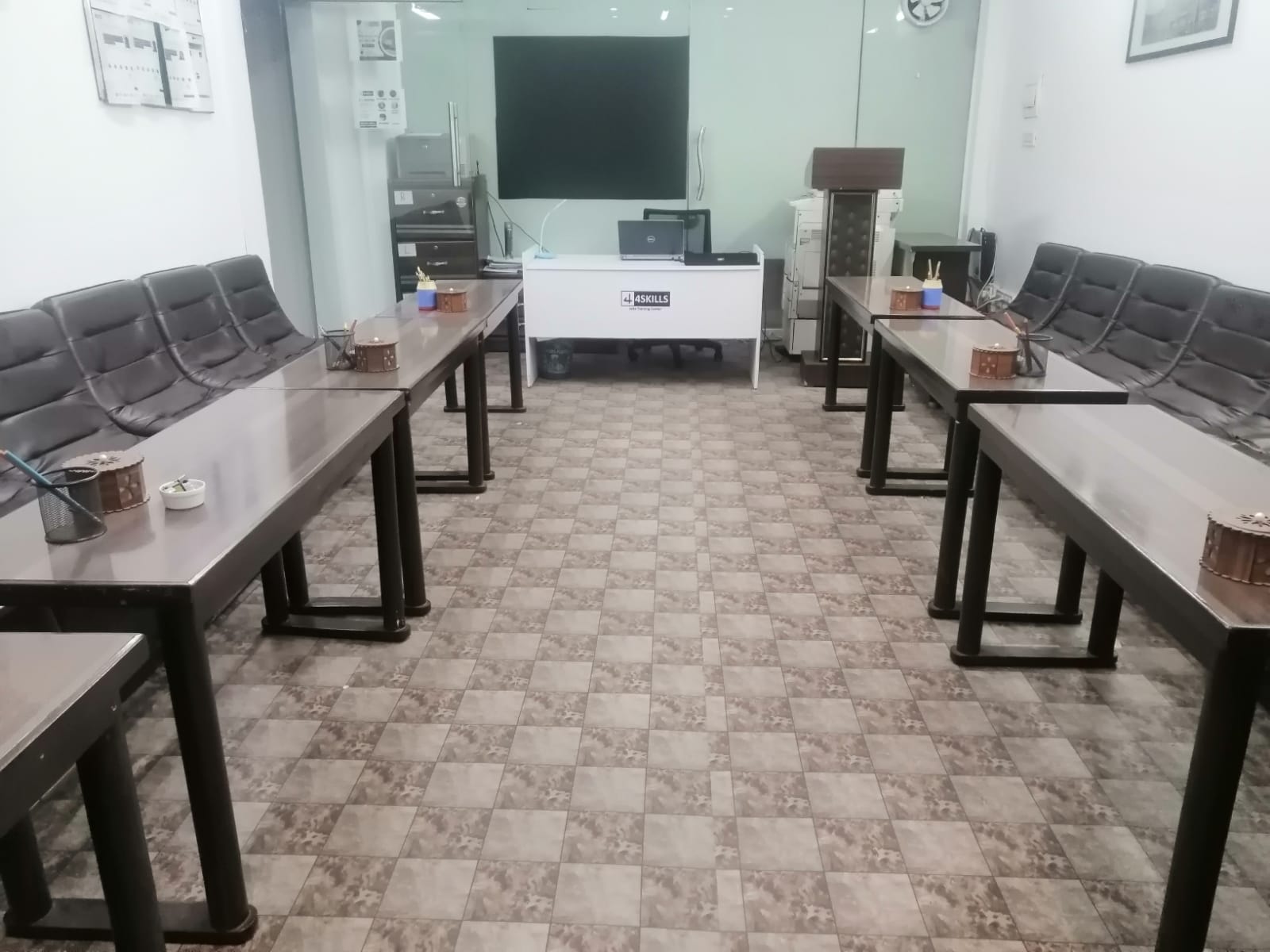 An IELTS training session under way at the 4Skills centre in Faisalabad, students seated at desks with practice materials